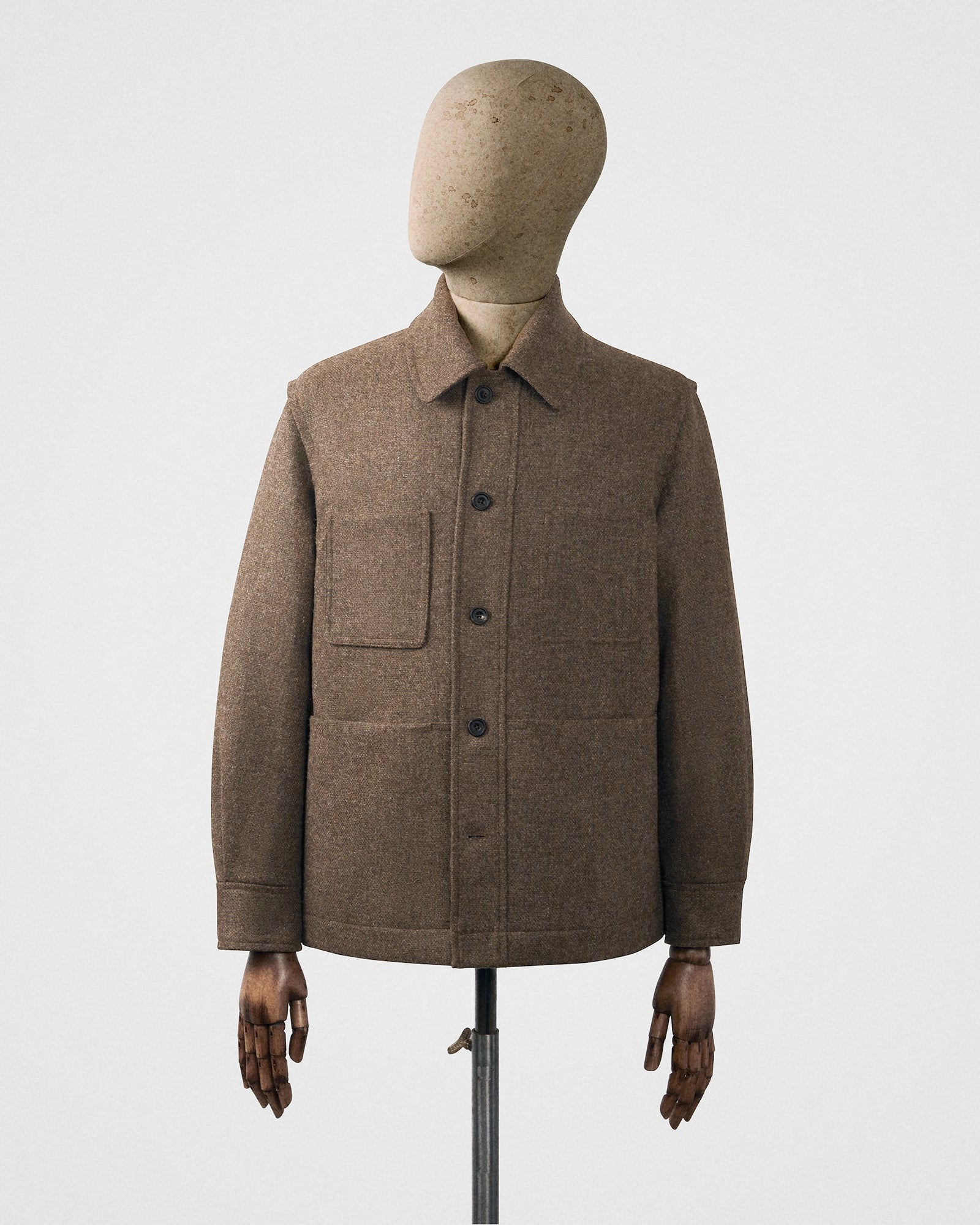 Brown jacket on a mannequin against a white background