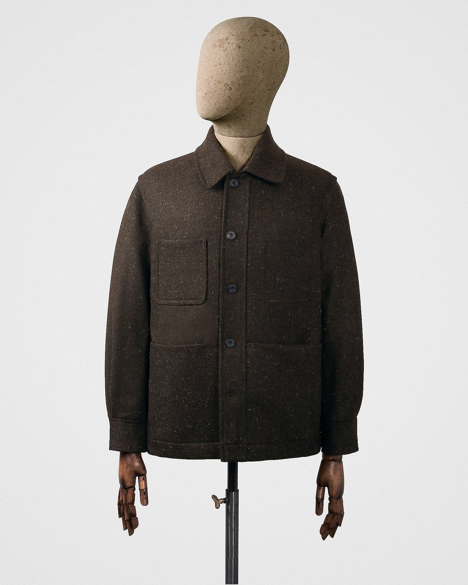 Brown coat on a mannequin against a white background